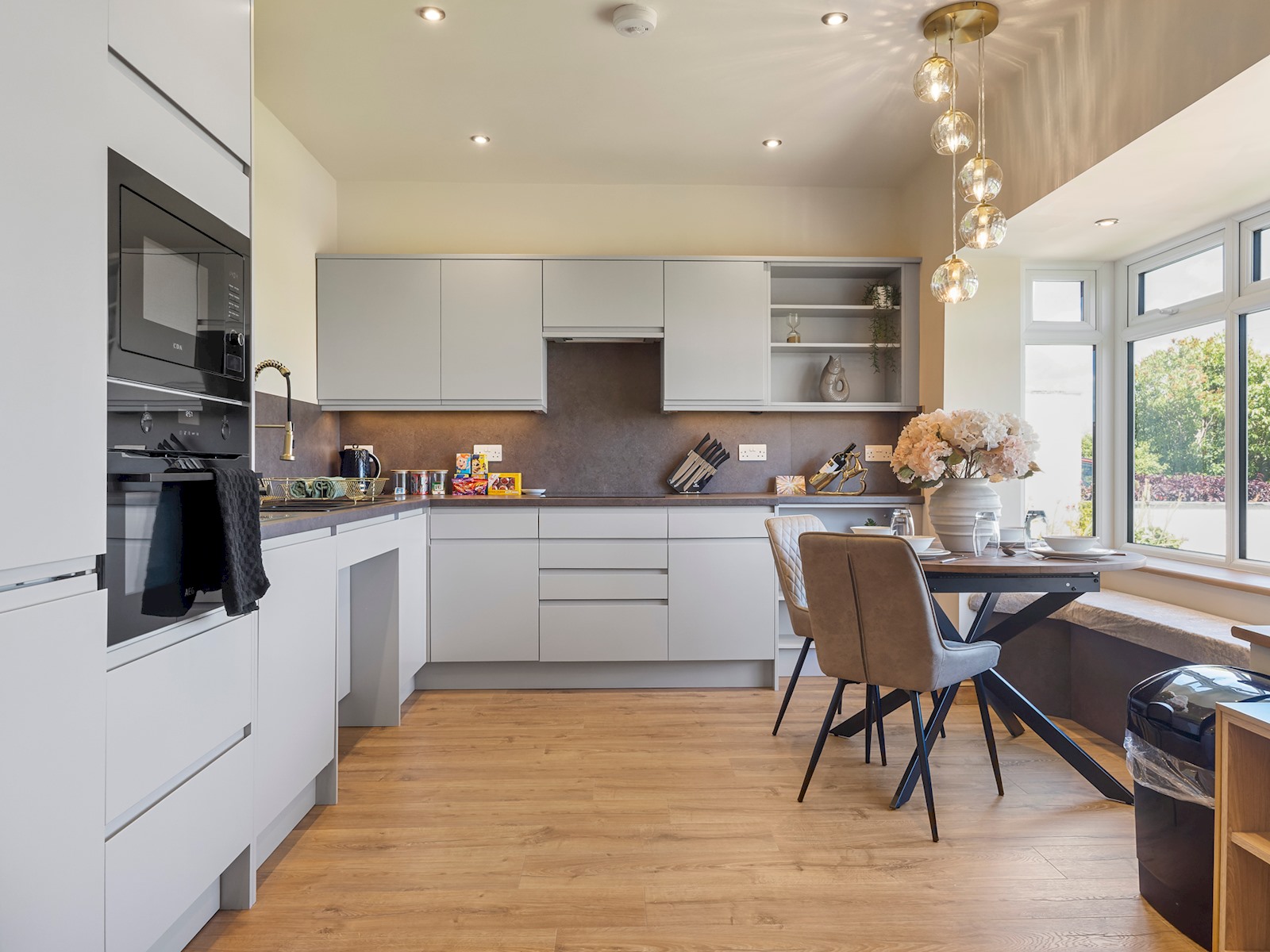Modern accessible kitchen with oven and dining area